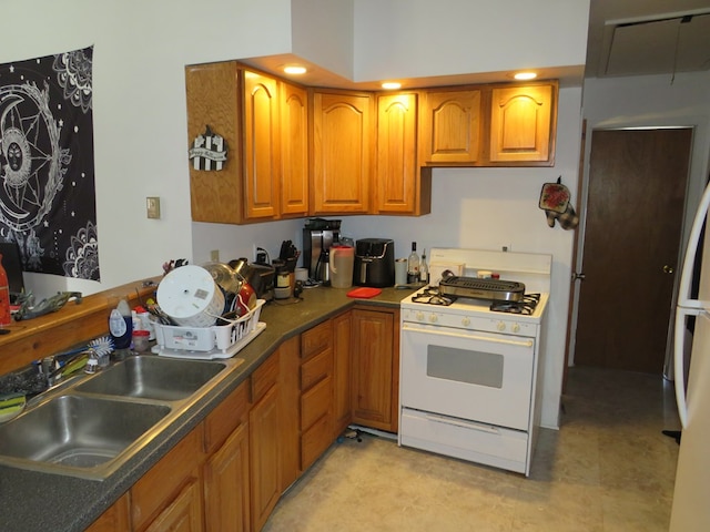 kitchen with white gas range and sink