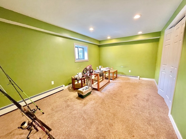 rec room featuring a baseboard heating unit and carpet floors