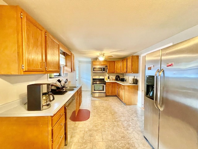 kitchen featuring ceiling fan, appliances with stainless steel finishes, and sink