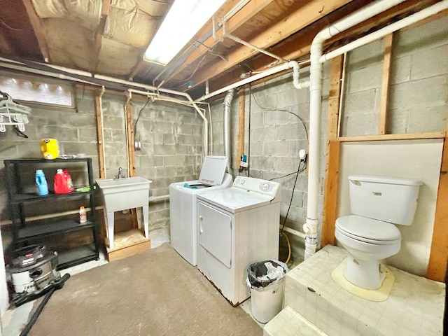 interior space featuring independent washer and dryer and sink