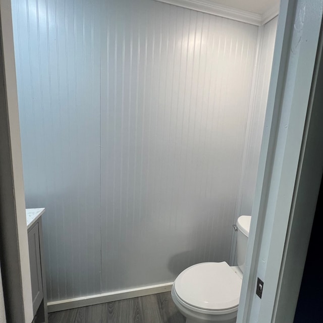 bathroom with hardwood / wood-style floors, vanity, and toilet