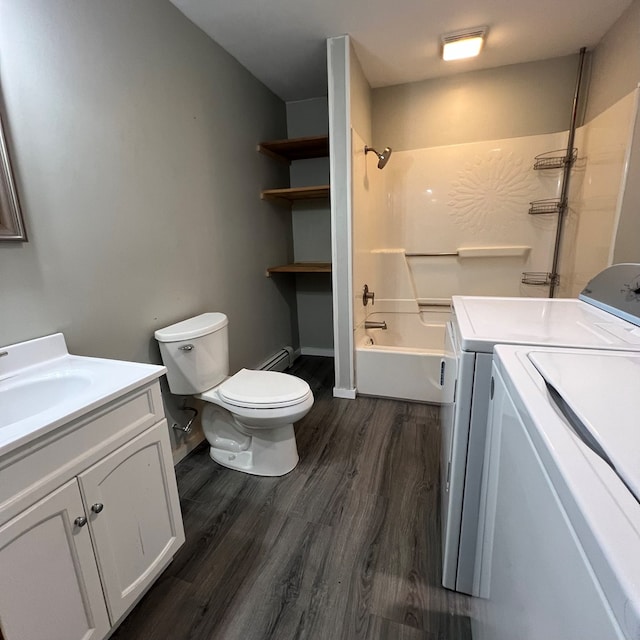 full bathroom with washer and clothes dryer, vanity, a baseboard heating unit, hardwood / wood-style flooring, and toilet