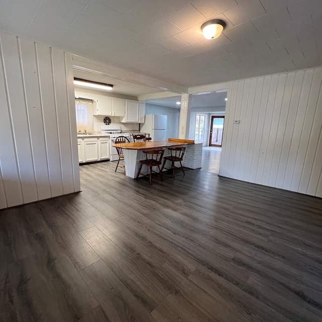 unfurnished dining area featuring dark hardwood / wood-style floors