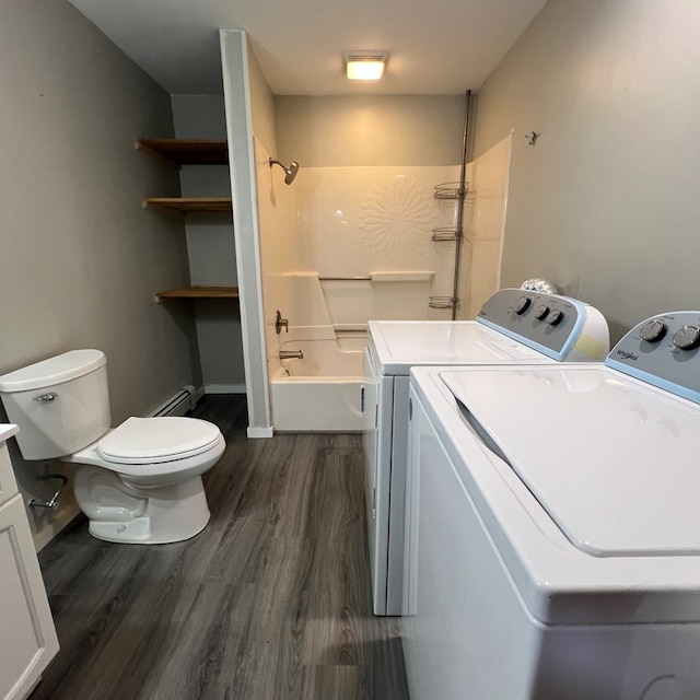 washroom featuring dark wood-type flooring, washer and dryer, and a baseboard heating unit