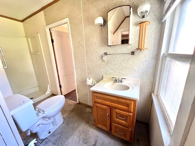 bathroom with vanity, toilet, ornamental molding, and a shower