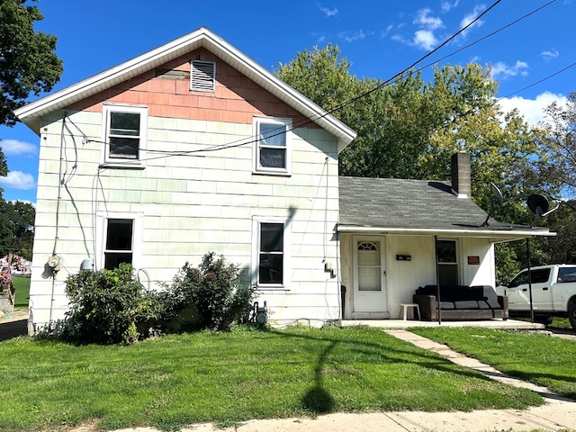 view of front facade with a front yard and a porch