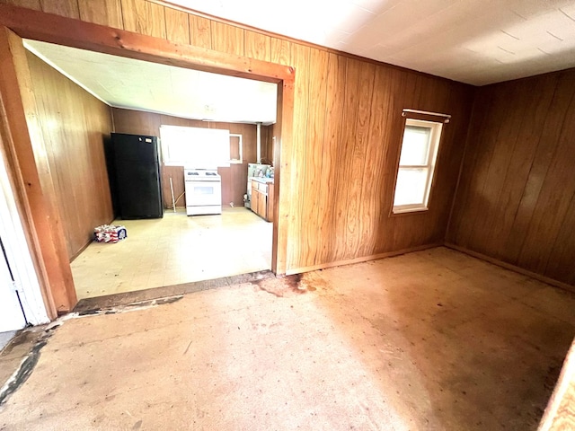 empty room with plenty of natural light and wood walls