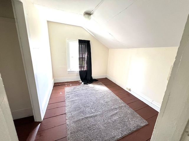 bonus room with dark hardwood / wood-style flooring and lofted ceiling