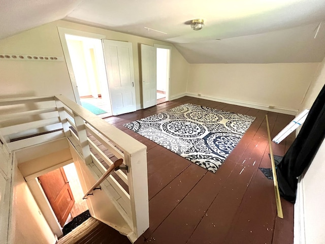 additional living space featuring dark hardwood / wood-style flooring and vaulted ceiling