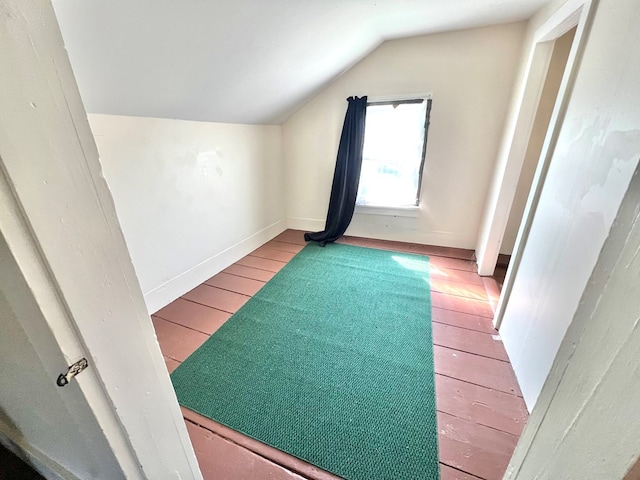 bonus room with light hardwood / wood-style flooring and vaulted ceiling