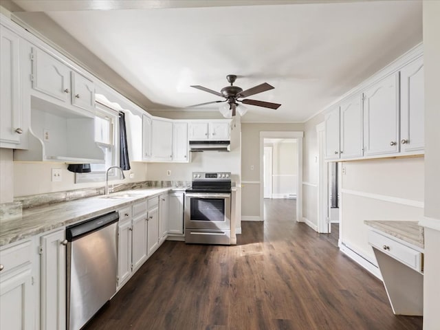 kitchen with sink, ceiling fan, light stone counters, white cabinetry, and stainless steel appliances