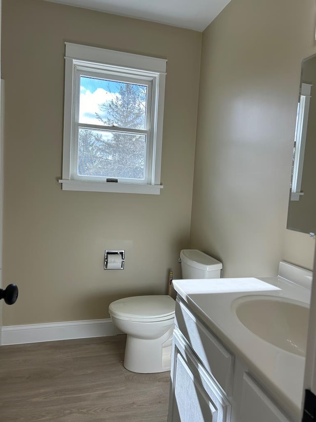 bathroom featuring hardwood / wood-style floors, vanity, and toilet