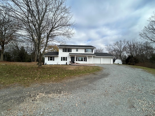 342 Smoke Rise Rd, Mansfield, PA 16933 - traditional home with gravel driveway, an attached garage, a porch, and a front yard