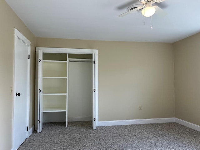 unfurnished bedroom with ceiling fan, a closet, and carpet floors