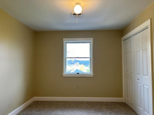 unfurnished bedroom with a closet and carpet