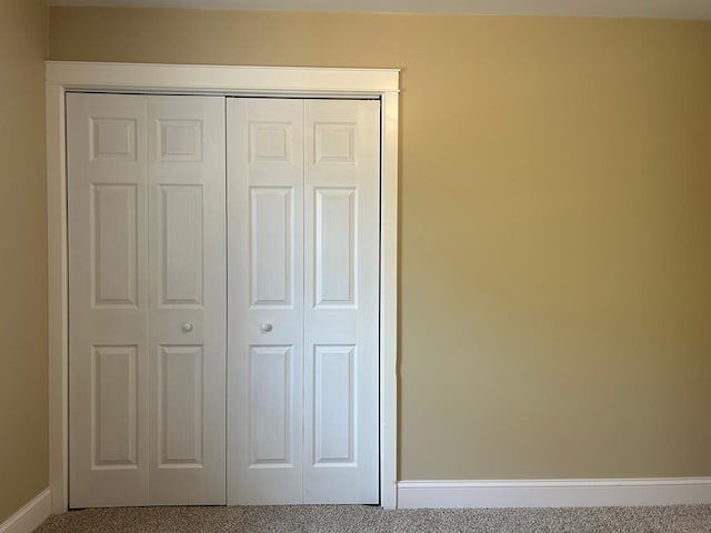 unfurnished bedroom featuring a closet and carpet floors