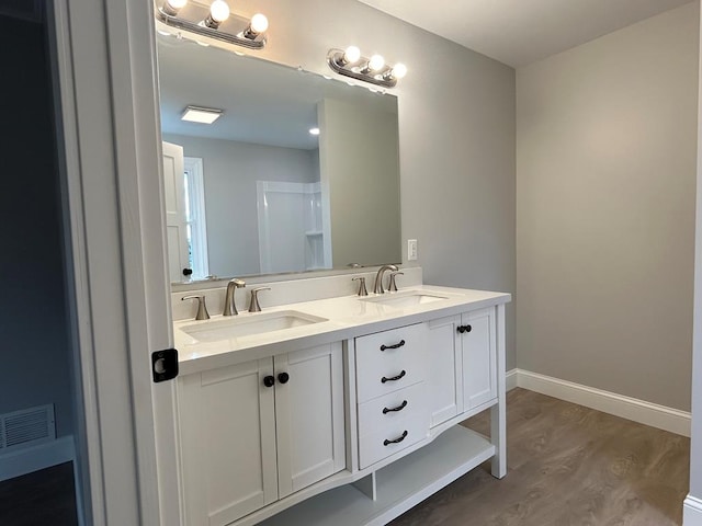 bathroom with hardwood / wood-style floors and vanity