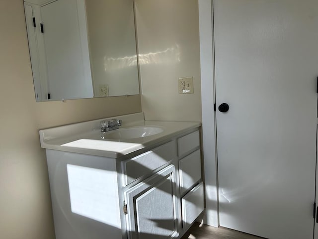 bathroom with hardwood / wood-style floors and vanity