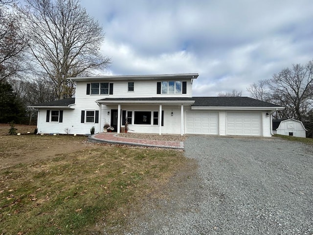 342 Smoke Rise Rd, Mansfield, PA 16933 - traditional home with gravel driveway, a garage, covered porch, and a front yard