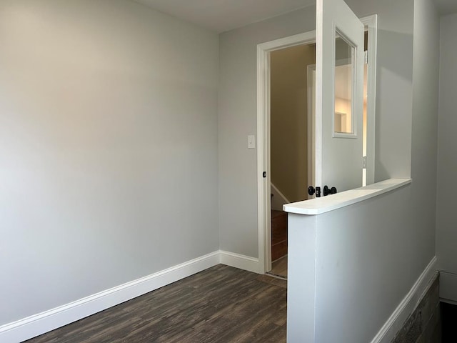 hallway with dark hardwood / wood-style flooring