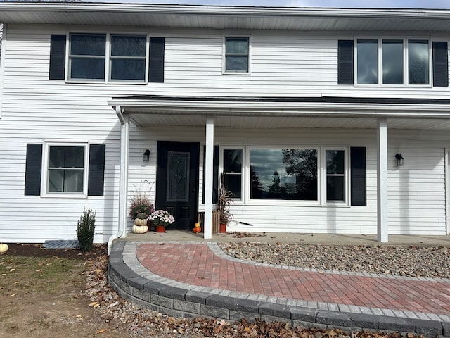 view of exterior entry with a porch