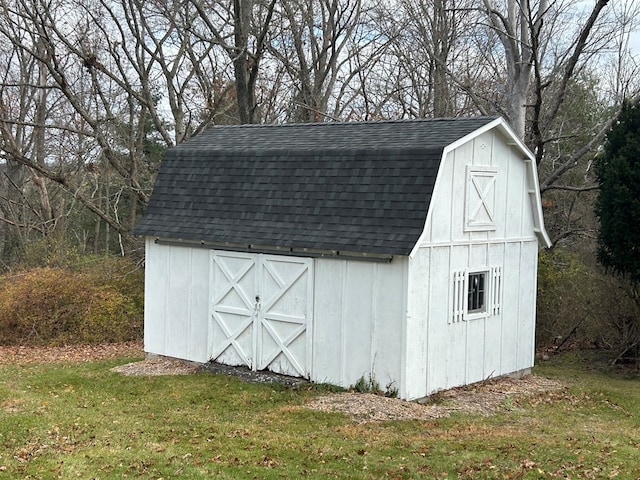 view of outdoor structure featuring a lawn