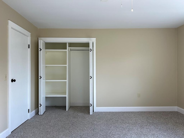 unfurnished bedroom with carpet and a closet