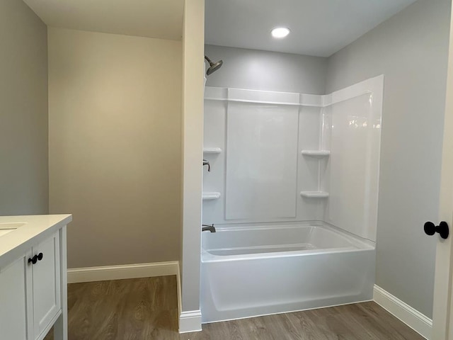 bathroom featuring bathing tub / shower combination, vanity, and hardwood / wood-style flooring