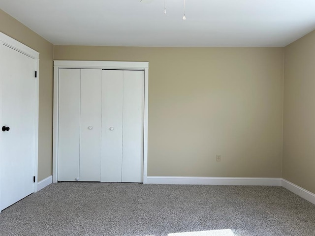 unfurnished bedroom featuring a closet and carpet