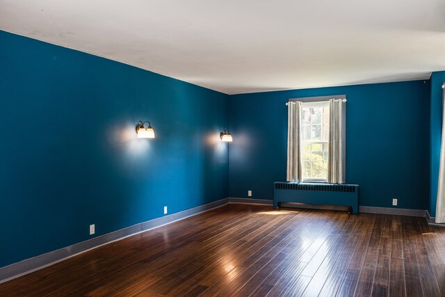 213 Holden St, Osceola, PA 16942 - unfurnished room with radiator heating unit, wood finished floors, and baseboards