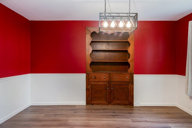 213 Holden St, Osceola, PA 16942 - unfurnished dining area featuring wainscoting and wood finished floors