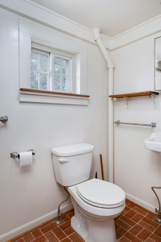 213 Holden St, Osceola, PA 16942 - bathroom featuring toilet, baseboards, and brick patterned flooring