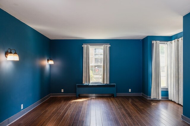 213 Holden St, Osceola, PA 16942 - unfurnished room featuring radiator, healthy amount of natural light, wood-type flooring, and baseboards