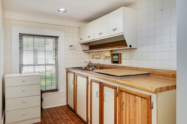 213 Holden St, Osceola, PA 16942 - kitchen with a sink, brick patterned flooring, backsplash, and wood counters