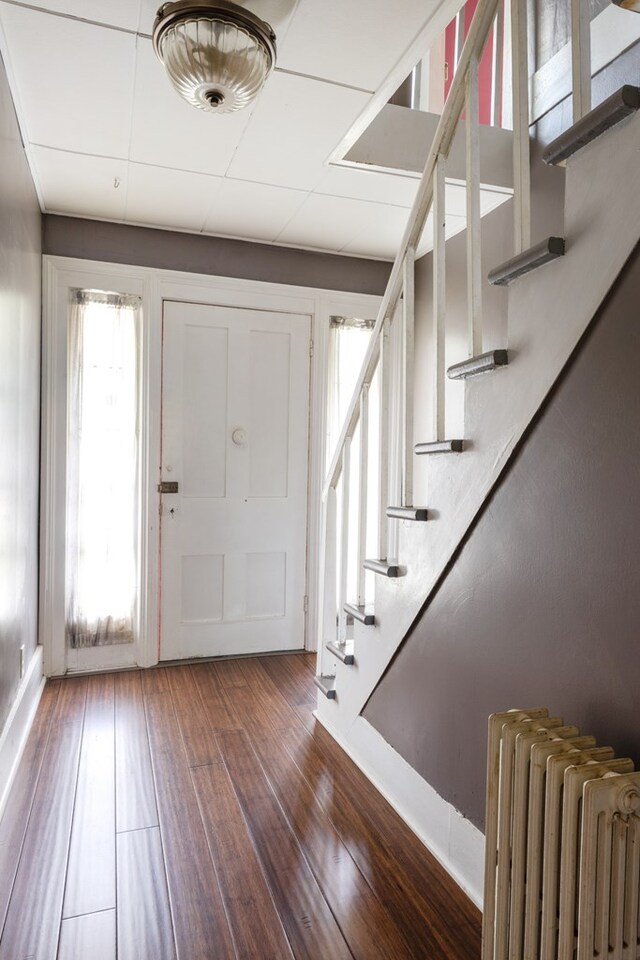 213 Holden St, Osceola, PA 16942 - foyer with radiator heating unit, hardwood / wood-style floors, stairs, and baseboards