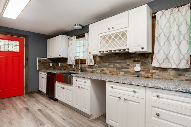 213 Holden St, Osceola, PA 16942 - kitchen with a sink, white cabinetry, tasteful backsplash, and light wood-type flooring