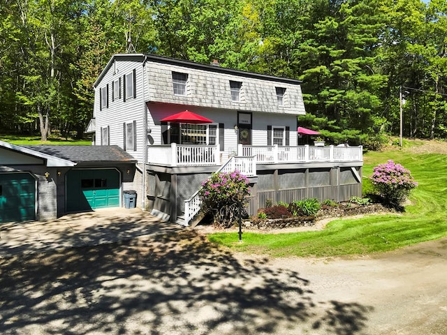 3046 Old Plank Rd, Towanda, PA 18848 - view of front facade with asphalt driveway, a chimney, a garage, a deck, and stairway