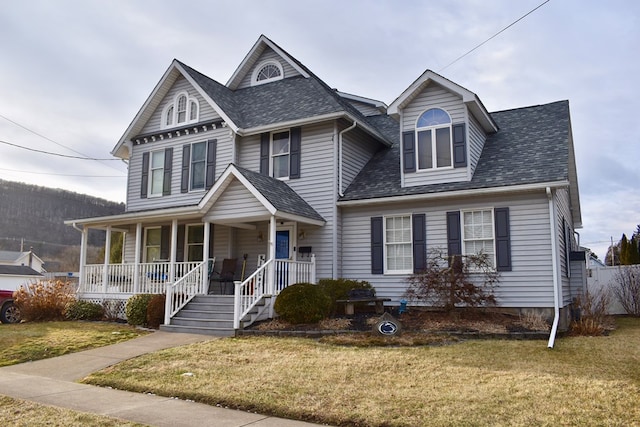 view of front of property with covered porch and a front yard