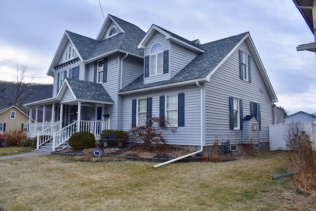 view of front of home featuring a front yard and covered porch