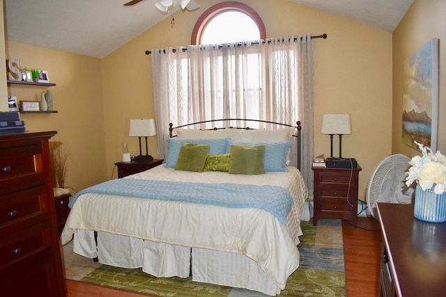 bedroom featuring vaulted ceiling, hardwood / wood-style floors, and ceiling fan