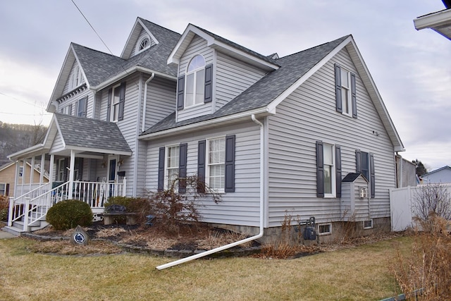 exterior space featuring covered porch and a lawn