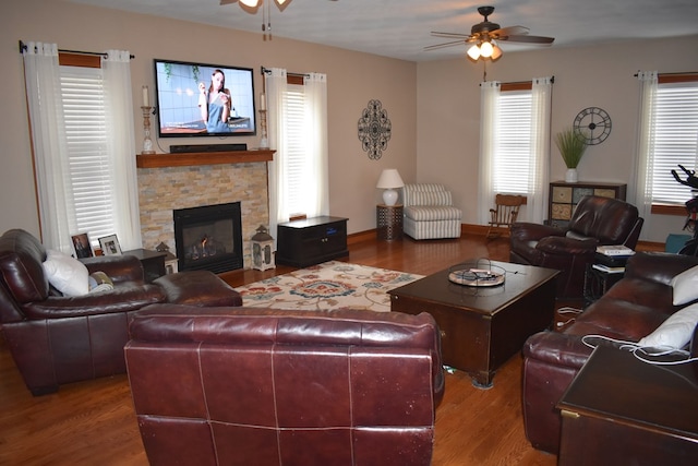 living room with hardwood / wood-style floors, a fireplace, and ceiling fan