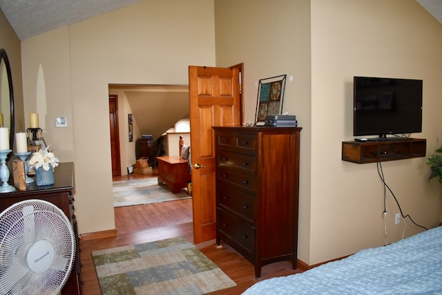 bedroom featuring hardwood / wood-style flooring and lofted ceiling