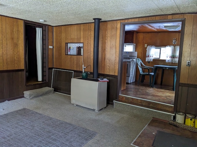 kitchen featuring carpet flooring, range, and wooden walls