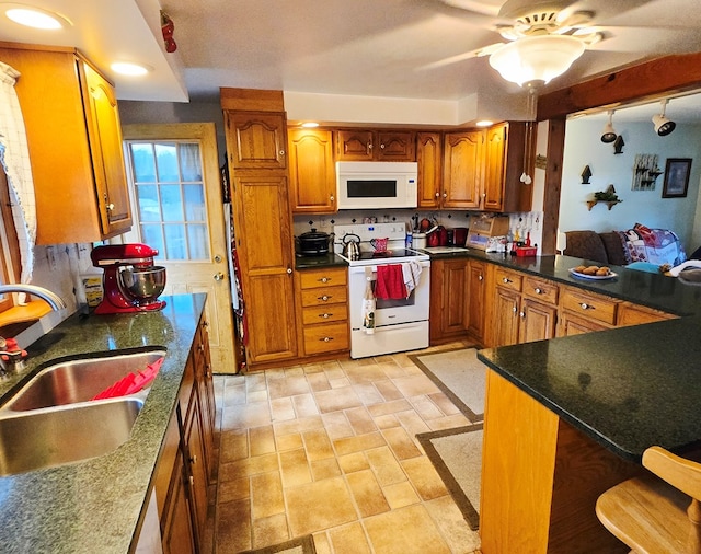 16 Evergreen Dr, Tunkhannock, PA 12155 - kitchen featuring white appliances, a sink, brown cabinets, ceiling fan, and dark stone counters