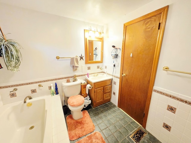 16 Evergreen Dr, Tunkhannock, PA 12155 - full bathroom featuring tile walls, a garden tub, toilet, vanity, and a wainscoted wall