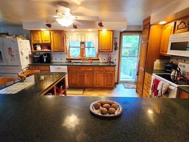 16 Evergreen Dr, Tunkhannock, PA 12155 - kitchen with white appliances, a sink, dark countertops, brown cabinetry, and ceiling fan