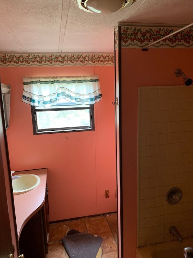 bathroom with shower / tub combination, tile patterned floors, vanity, and a textured ceiling