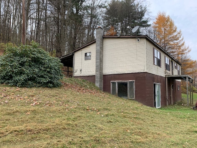 view of side of home with a yard