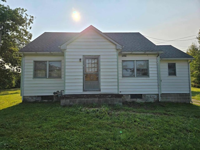 rear view of house featuring a yard